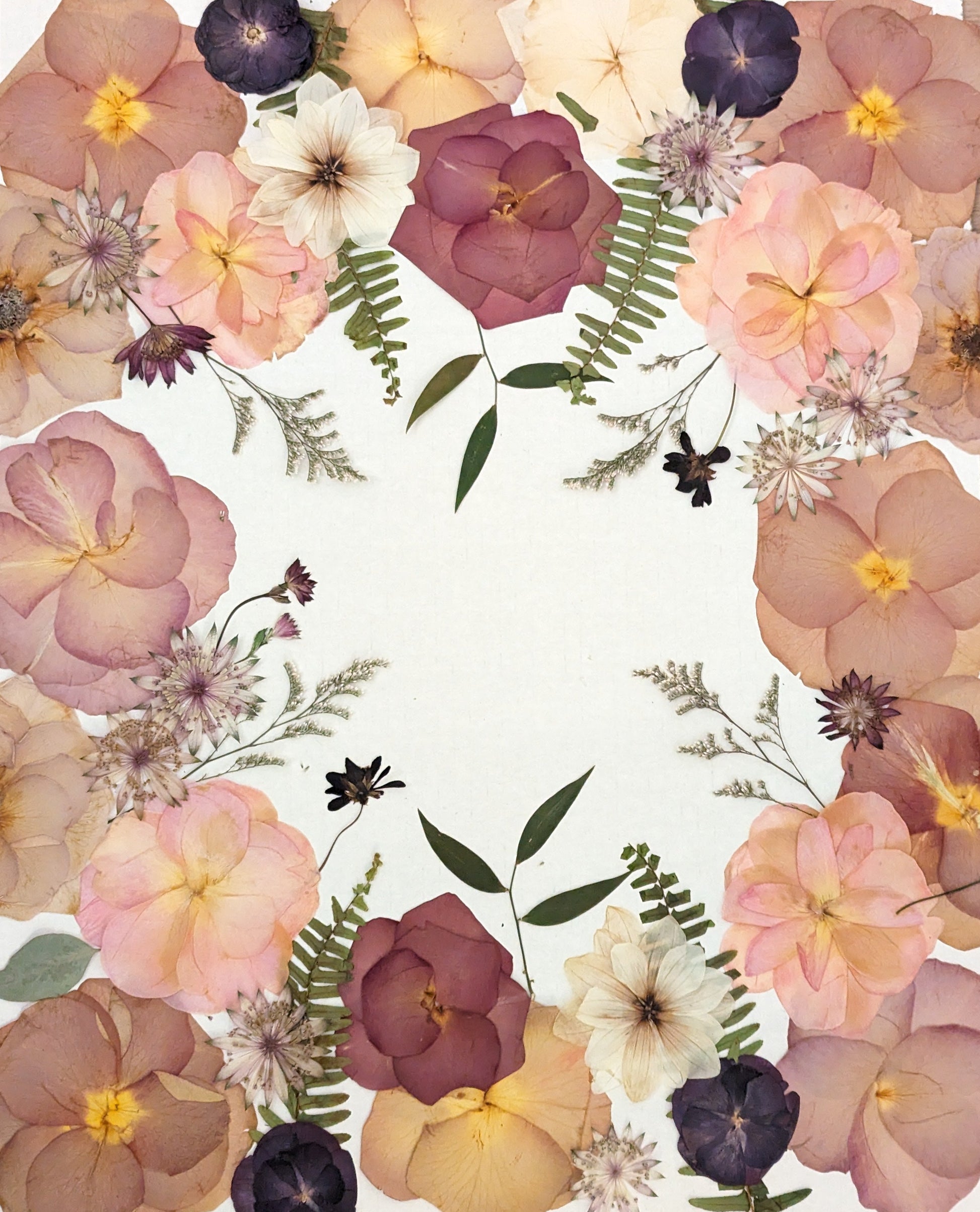 Floral arrangement on a white background with a wooden surface underneath