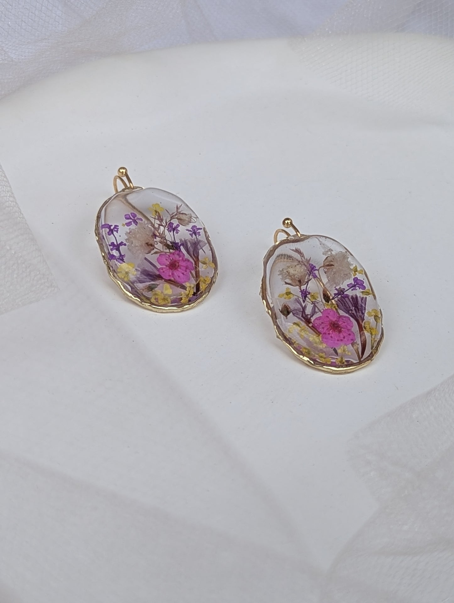 Two floral pendant necklaces on a white background